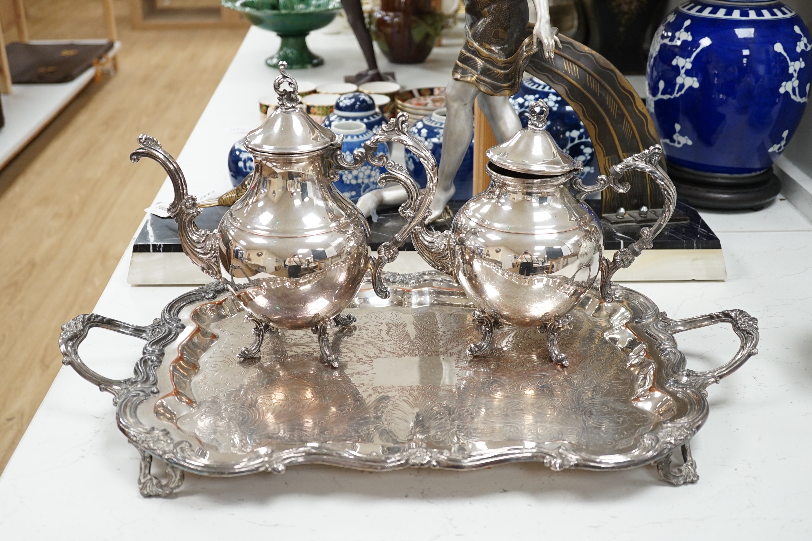 A silver plated two handled tray, a coffee and a teapot, tray 64cm wide